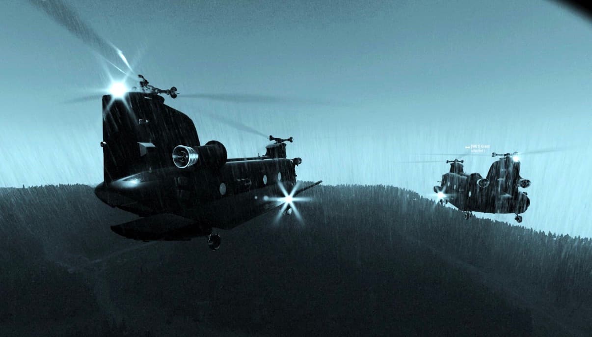 Two Chinook helicopters flying in rain